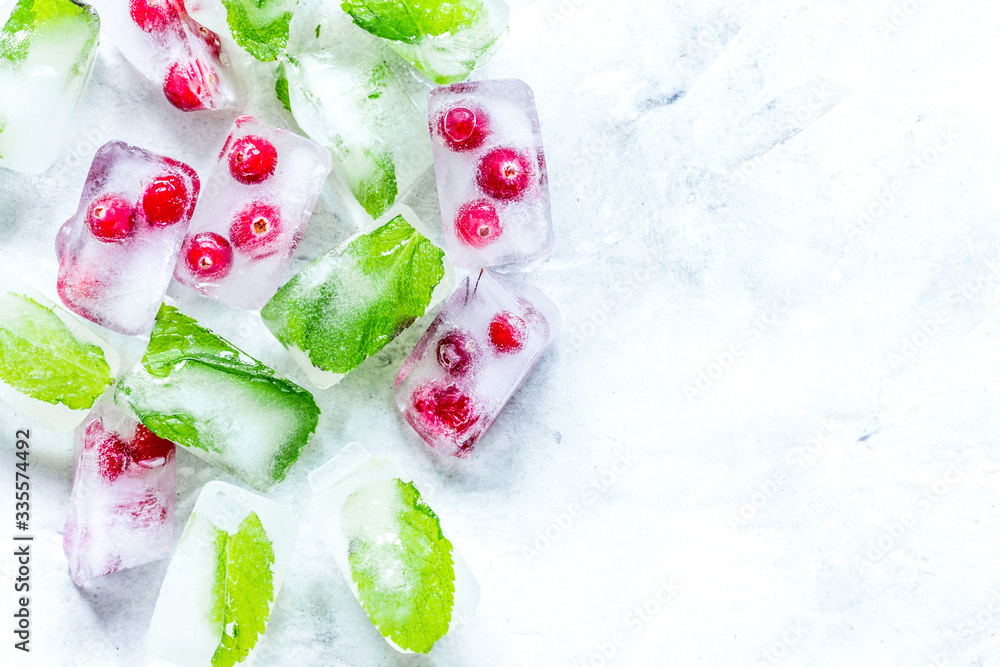 mint and red berries in ice cubes stone background top view mockup mint and red berries in ice cubes stone background top view mockup