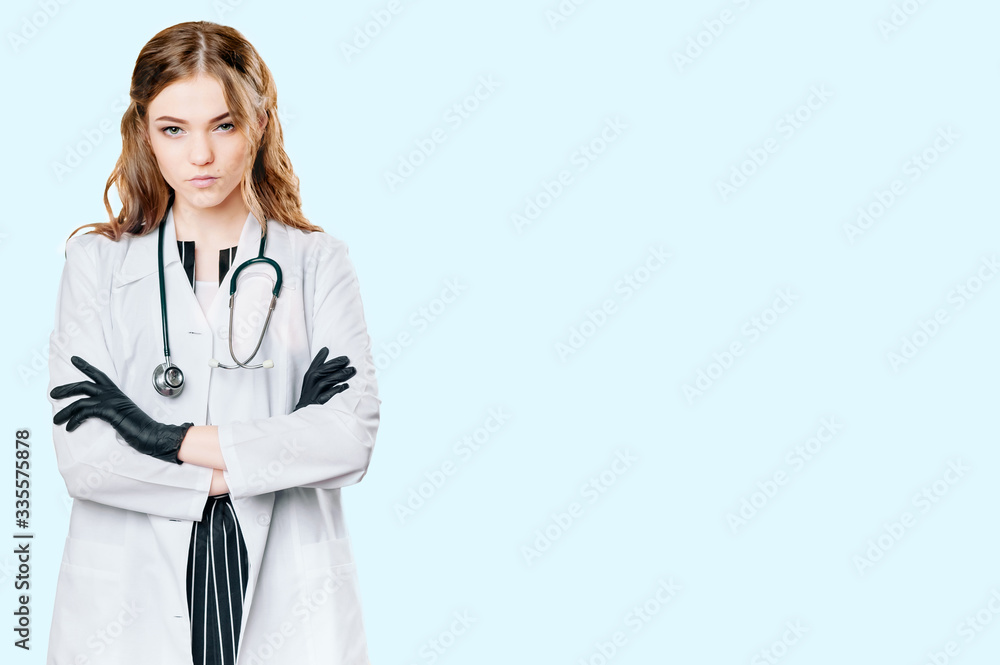 Gloomy girl doctor with a stethoscope. On a blue background Gloomy girl doctor with a stethoscope. On a blue background