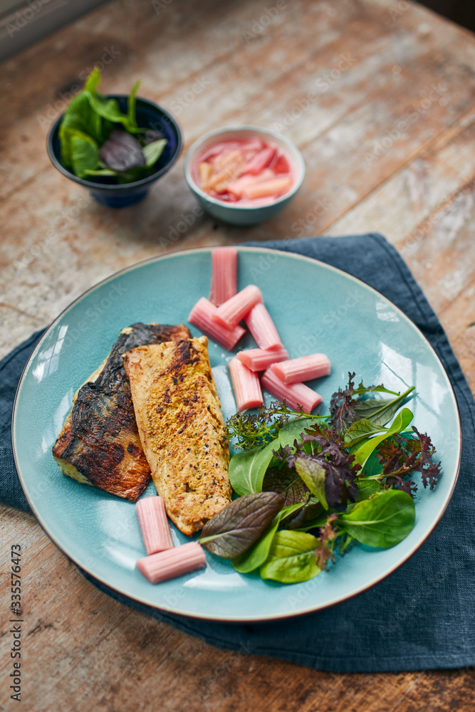 Grilled fish with stewed rhubarb and green salad