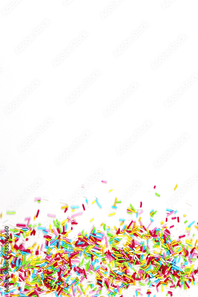 Fototapeta premium culinary pastry rainbow sprinkles are scattered on a white background