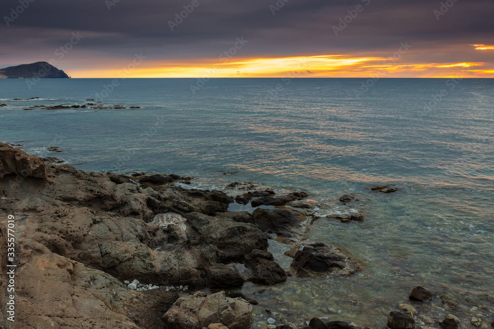 Fototapeta premium Sunrise on the coast of Escullos. Natural Park Cabo de Gata. Spain.