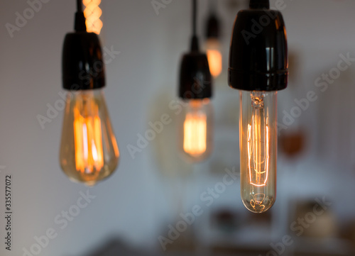 Edison lamp with warm light sways lightly background. Warm.
