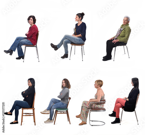 group of women sitting on chair on white background, side view photo