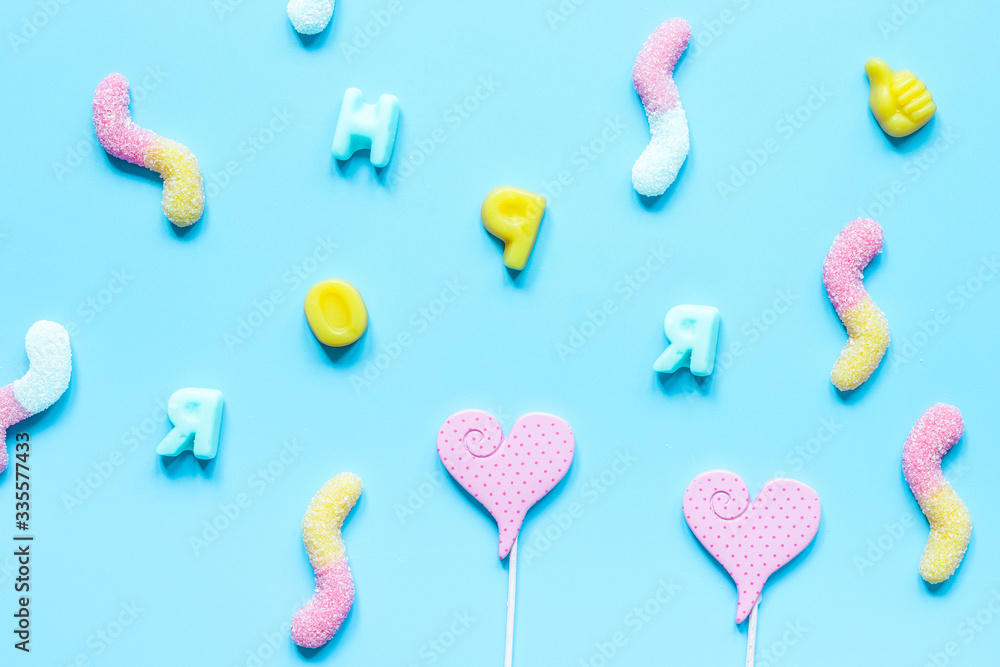 sweets and sugar candies on blue background top view pattern sweets and sugar candies on blue background top view pattern