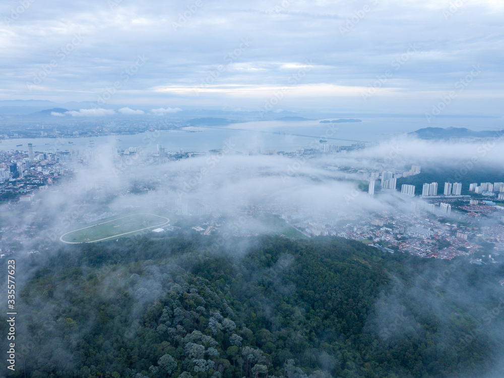 Aerial view Penang Turf Club over sea cloud at Penang Hill in cloudy morning.