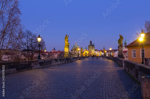 Night colorful Prague Old Town with Bridge Tower and St. Francis of Assisi Cathedral from Charles Bridge with its baroque Statues without People at the time of Coronavirus, Czech republic © Kajano