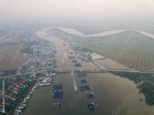 Aerial view busy fishing village at Kuala Kurau in haze morning. photo