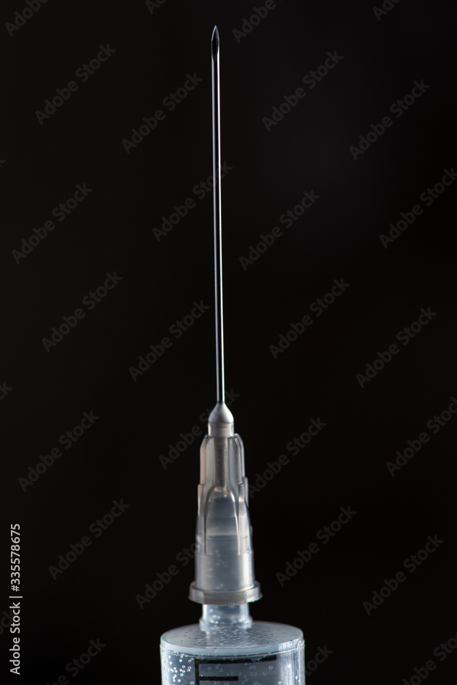 Syringe with medicine on a dark background. Photographed close-up. Syringe with medicine on a dark background. Photographed close-up.