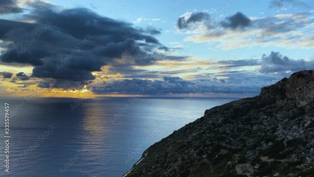 Sunset over the sea timelapse. Golden sun rays shining through the dark stormy clouds. Sunset over the sea timelapse. Golden sun rays shining through the dark stormy clouds.