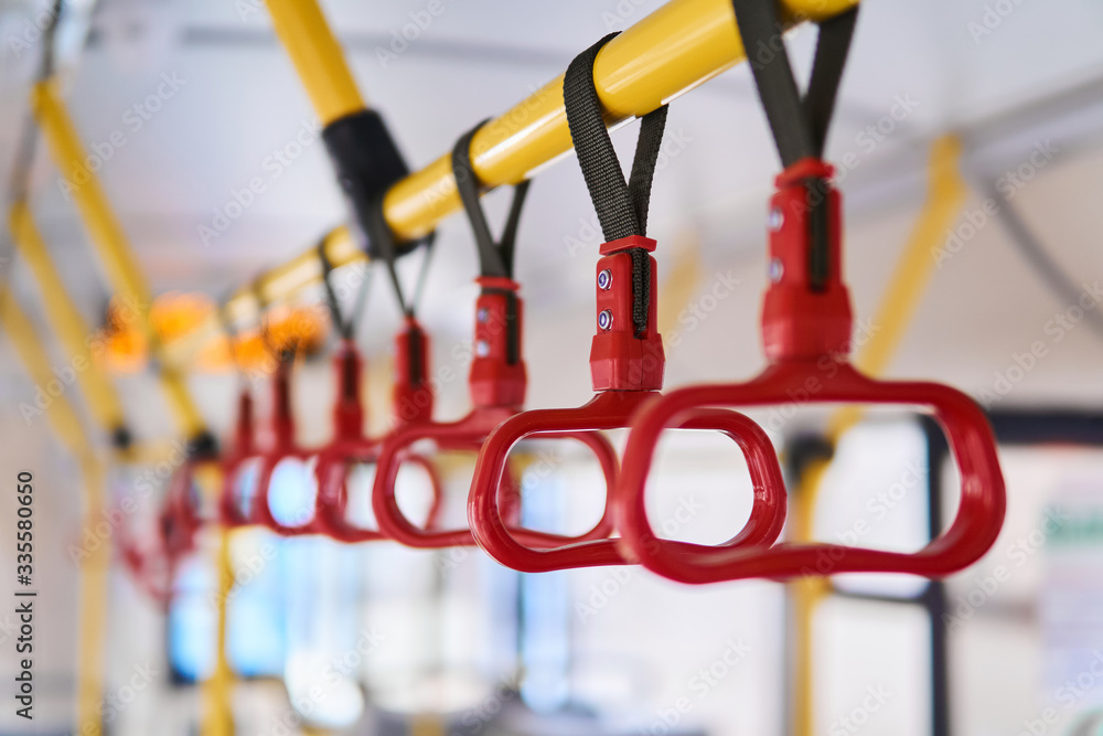 grab handles in the passenger compartment of the bus on a blurred background