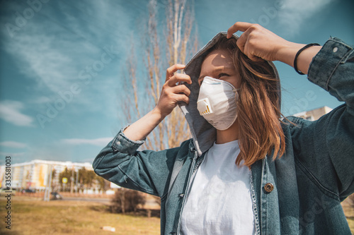 Girl in a respirator in the city