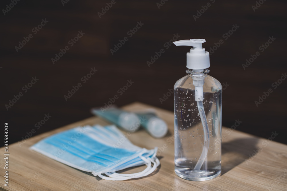 Hand sanitizer gel Anti virus protection and medical surgical masks with standard to prevent coronavirus COVID-19 infection.Medical protective on wood background.Healthcare and medical concept. Hand sanitizer gel Anti virus protection and medical surgical masks with standard to prevent coronavirus COVID-19 infection.Medical protective on wood background.Healthcare and medical concept.