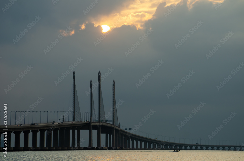 Fototapeta premium Sun appear through cloud at Penang second bridge in morning.