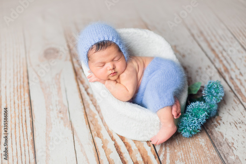 the first photo session of a newborn. a newborn baby is in the chair position