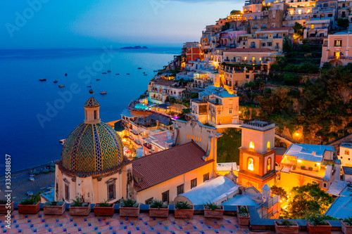 Positano, Amalfi Coast, Campania, Sorrento, Italy. View of the town and seaside in a summer sunset photo