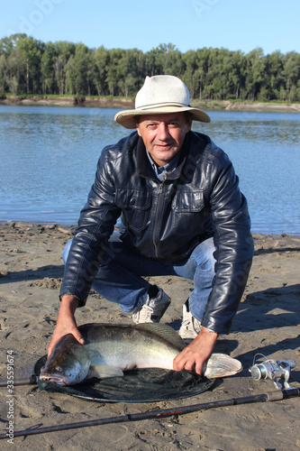 Fisher and his fish photo