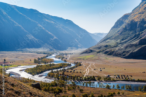 Chalet on the river bank in a mountain valley. Russia, Altai Republic, Ulagansky District, Chulyshman River, Akkrum tract