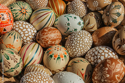 Full background of colorful, hand painted Easter eggs. Easter eggs in a wooden basket.Spring decoration. Painted Easter eggs.Festive tradition.Selective focus.Handmade Easter eggs