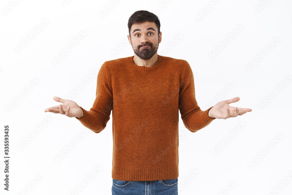 Portrait of puzzled and unaware attractive bearded man, shrugging with hands spread sideways, dont know what do, standing indecisive, need help with decision, cant understand, white background Portrait of puzzled and unaware attractive bearded man, shrugging with hands spread sideways, dont know what do, standing indecisive, need help with decision, cant understand, white background