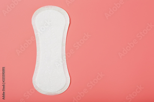 Sanitary pad on a pink background. Free space, isolate.
