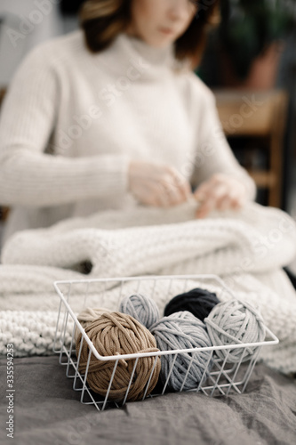Homemade hobby knitting Scandinavian cozy stylish rugs made of yarn. Knitted carpet or rug. Antique handmade carpet. Home hobby.