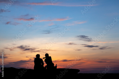 Asian couple sitting on the beach