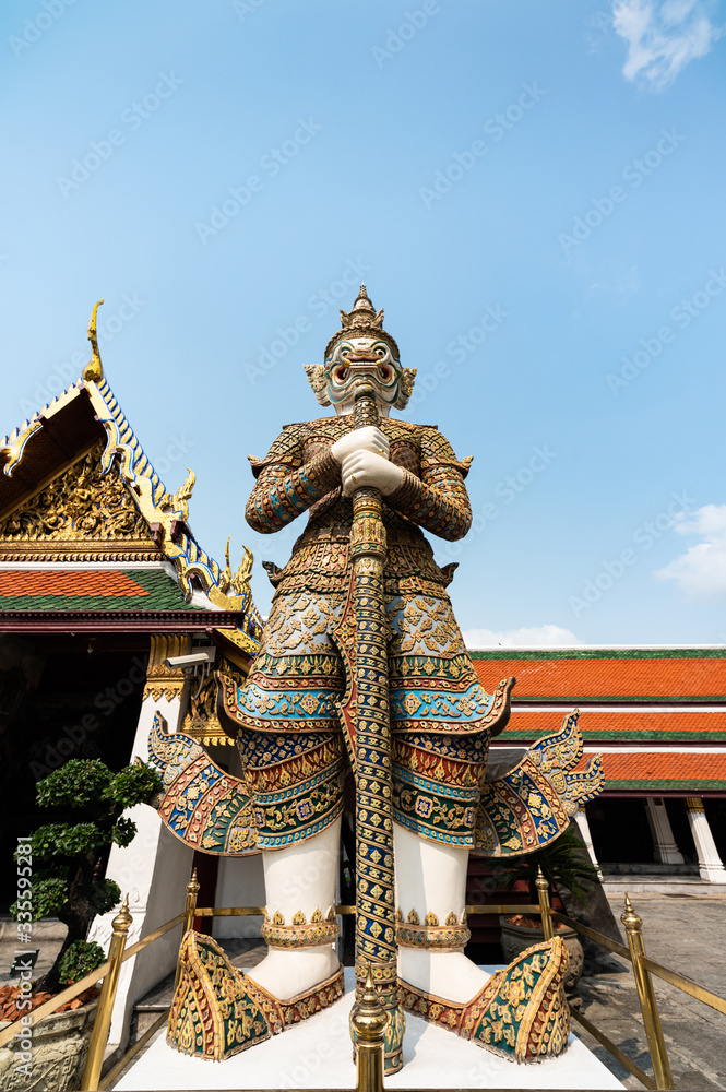 A standing giant guardian sculpture in Wat Prakaew Thailand