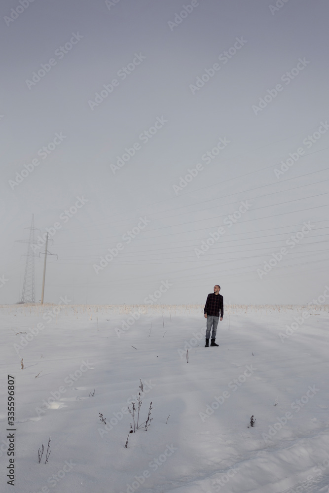 man alone foggy snowy field day alone