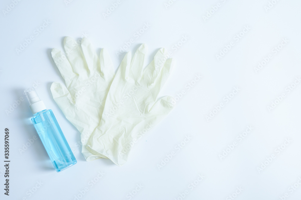 Medical gloves and sanitary alcohol spray on white background Medical gloves and sanitary alcohol spray on white background