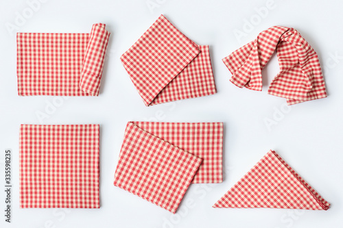 Red tablecloth or kitchen towel collection on white background. Cooking or baking mock up for design. Top view from above