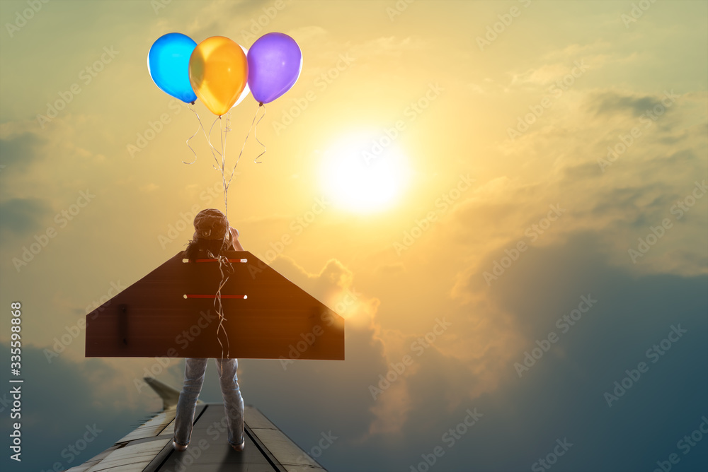 Cute little girl wear diy winged and captain's hat use binocular