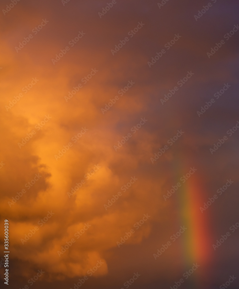 Dramatic sunset sky with clouds and a rainbow Dramatic sunset sky with clouds and a rainbow
