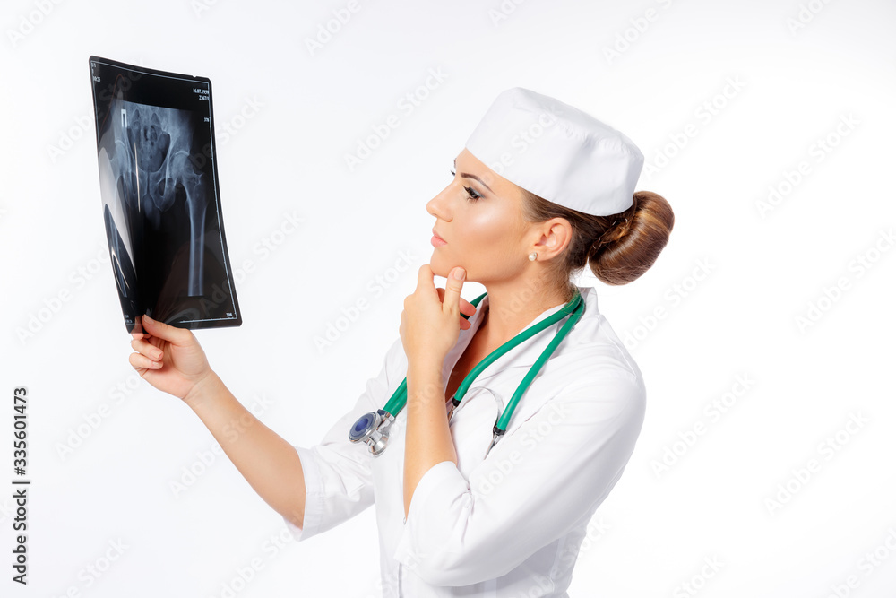 A doctor is watching an x-ray of a human lung. on a white background. beautiful girl. treatment of people