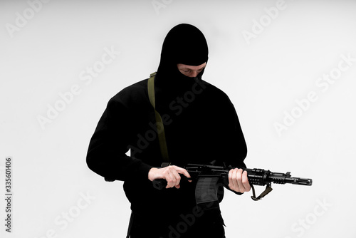 Man in mask With gun on white background 