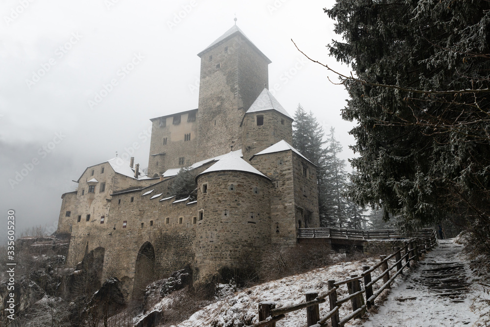 The castle of Tures (Burg Taufers) during a snowfall. One of the most interesting medieval castles in the province of Bolzano. Here the legend of Margarethe von Taufers is set. South Tyrol, Italy.