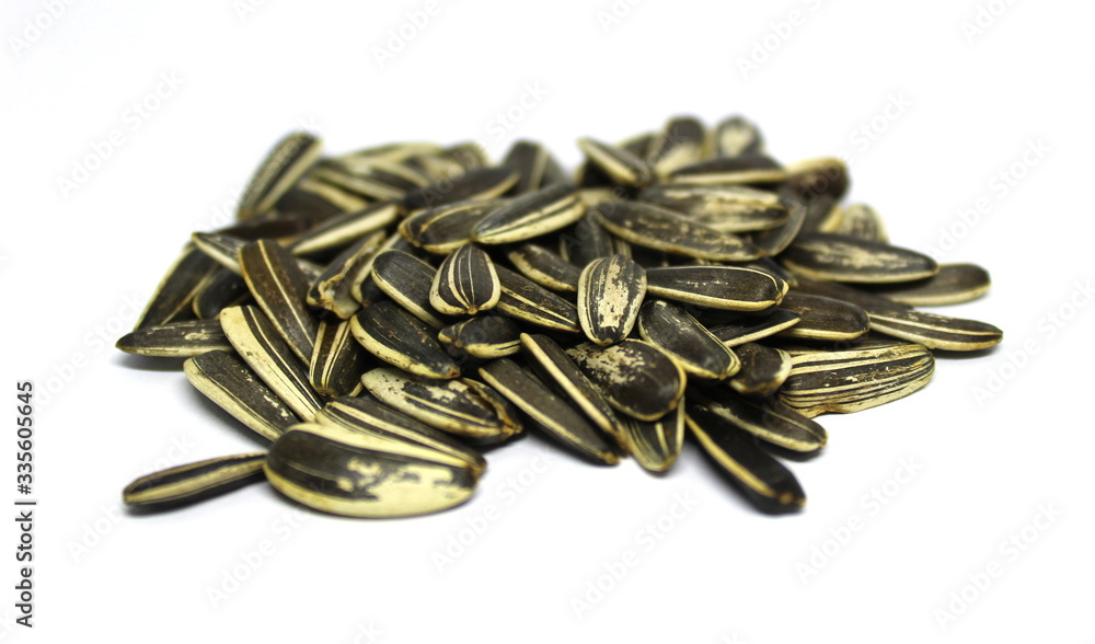Organic sunflower seed. Sunflower crack seeds isolated on the white background. Close up. Organic sunflower seed. Sunflower crack seeds isolated on the white background. Close up.