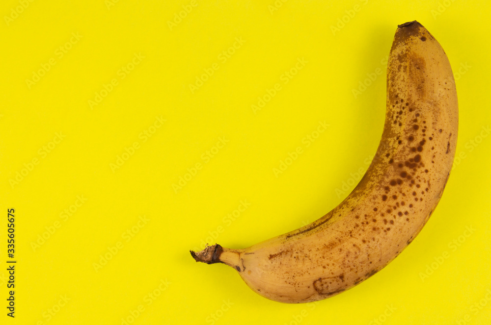 Yellow banana on a yellow background.copyspace for text Yellow banana on a yellow background.copyspace for text