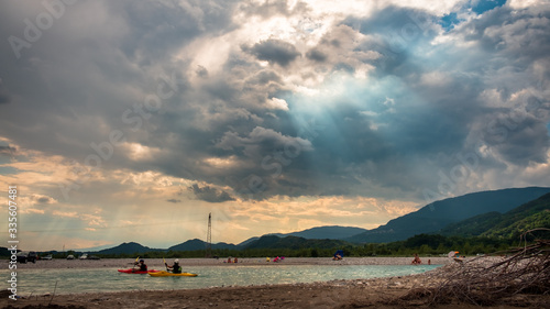 Storm over Tagliamento river in an hot summer day