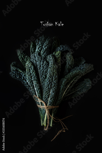 Bouquet of green Kale leaves on a dark background. Healthy detox vegetables . Clean eating and dieting concept.