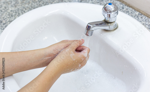 Young women wash their hands with soap to prevent bacterial and viral infections Corona or Covid-19, Inhibiting the spread and protection of the virus concept..