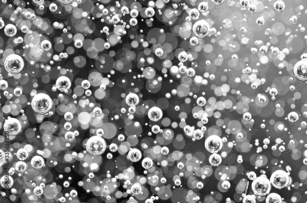 Blurred black and white background. Macro Oxygen bubbles in water. Concept such as ecology Blurred black and white background. Macro Oxygen bubbles in water. Concept such as ecology