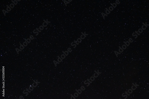 Long exposure night photo of a bright stars. A lot of stars with constellations. Far from the city. Night landscape.