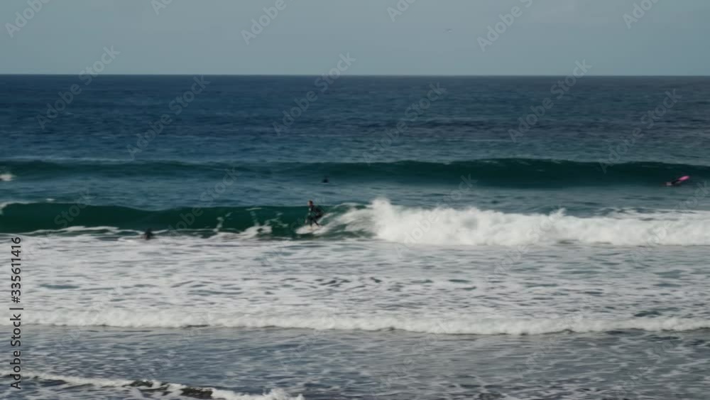 Surfer rides a wave in the Atlantic Ocean on the island of Tenerife. Surfer rides a wave in the Atlantic Ocean on the island of Tenerife.