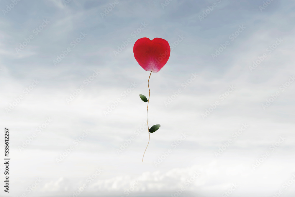 surreal moment of a heart-shaped flower that rises happily in the sky