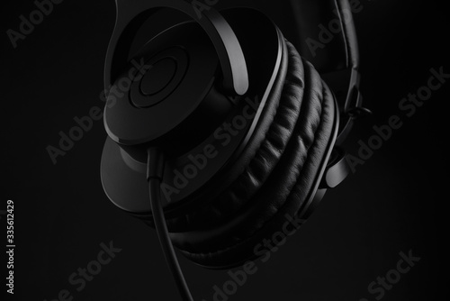 black headphones on a black background close-up