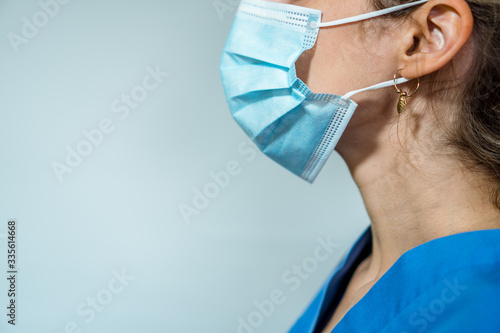Girl putting on a surgical mask photo
