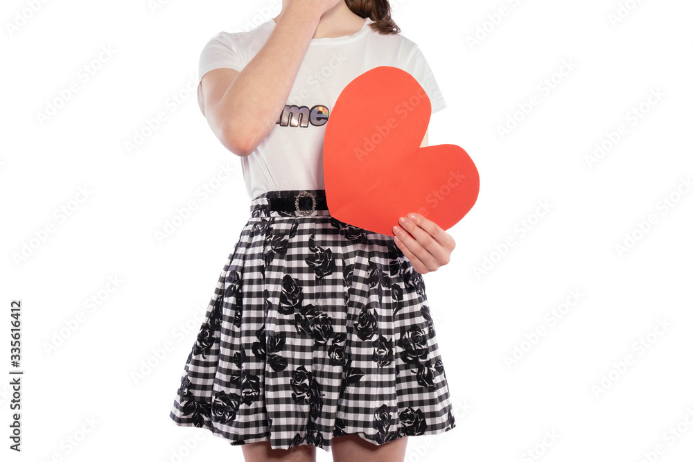 young girl holding a paper red heart in her hands