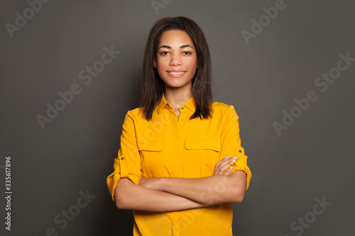 Smiling black woman in yellow shirt portrait
