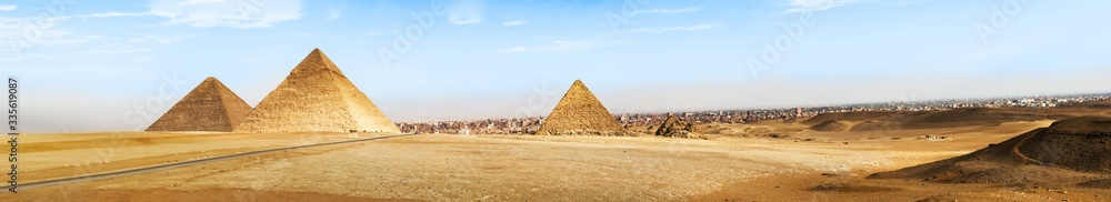 Pyramids of Giza on Sahara desert and city of Cairo at the background Pyramids of Giza on Sahara desert and city of Cairo at the background