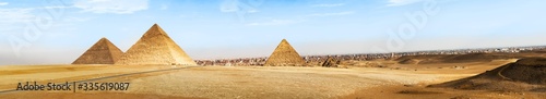 Pyramids of Giza on Sahara desert and city of Cairo at the background